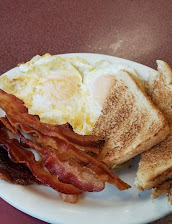 2 Eggs Over Easy With Toast And Bacon